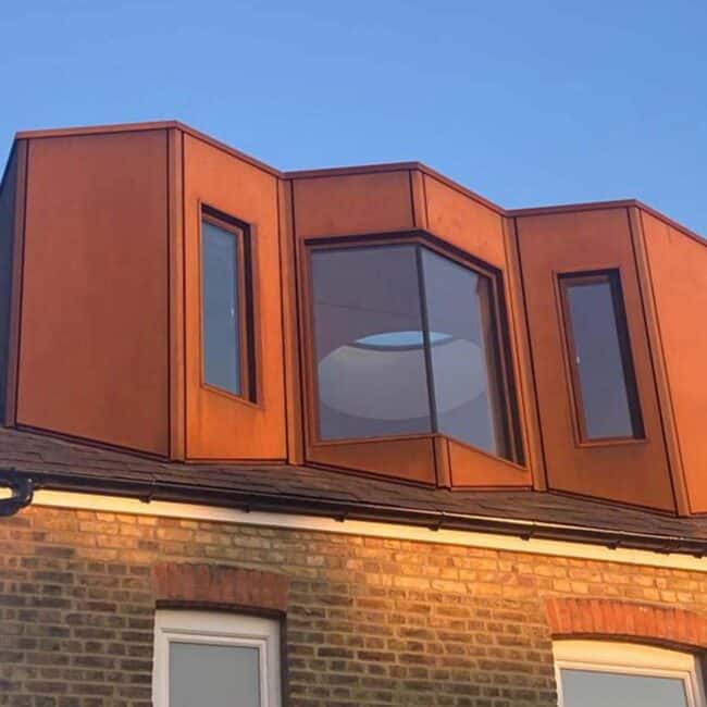 Corten dormer loft south london with frameless jointed glazing
